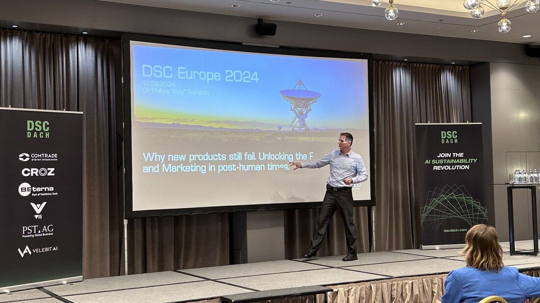 A speaker gestures at a title slide dated 13.09.2024, headed Why new products still fail.