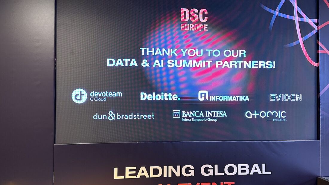 The stage screen thanking the Data and AI Summit partners: Devoteam G Cloud, Deloitte, Informatika, Eviden, Dun and Bradstreet, Banca Intesa and Atomic Intelligence