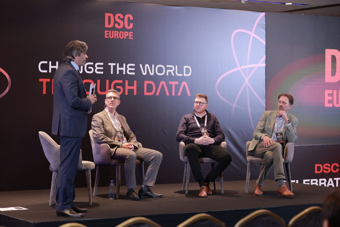 Four people on the main stage during a panel