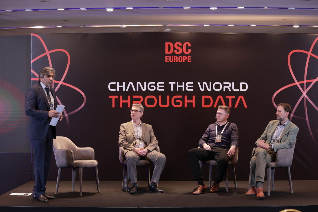 The host and three panellists on the main stage