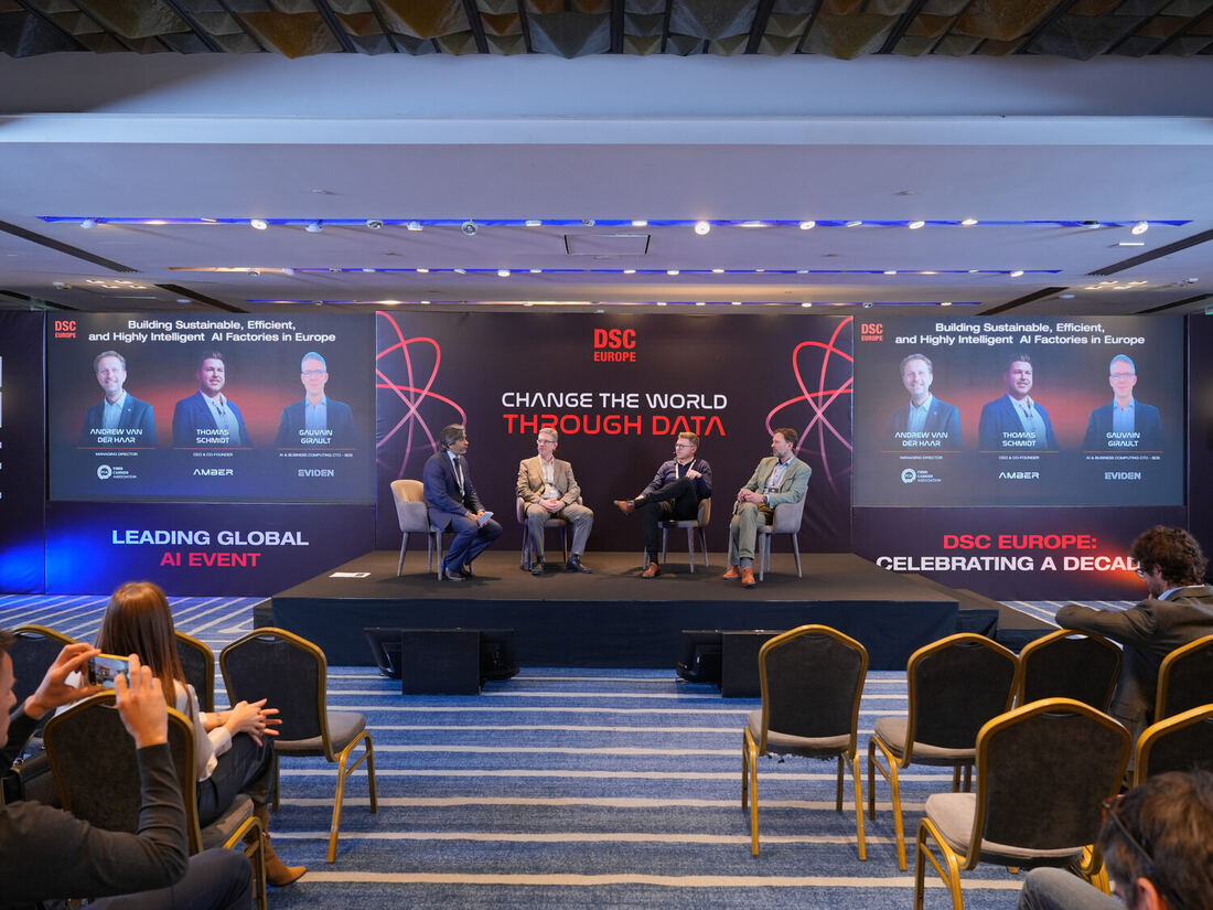 A wide view of the hall during a panel, the audience in the foreground