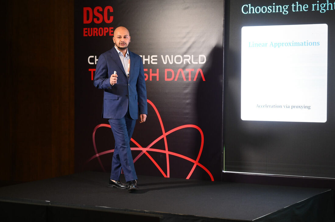 A speaker beside a screen on the DSC Europe stage, the slide headed Choosing the right