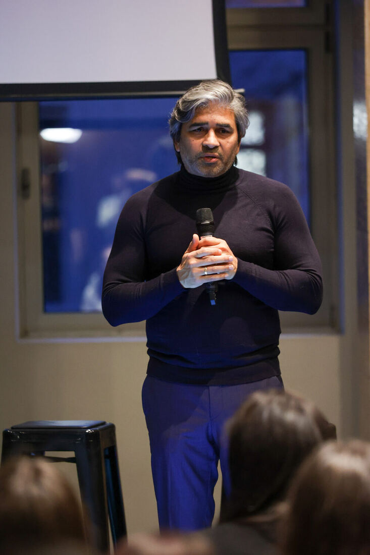 Tarry Singh speaking into a handheld microphone