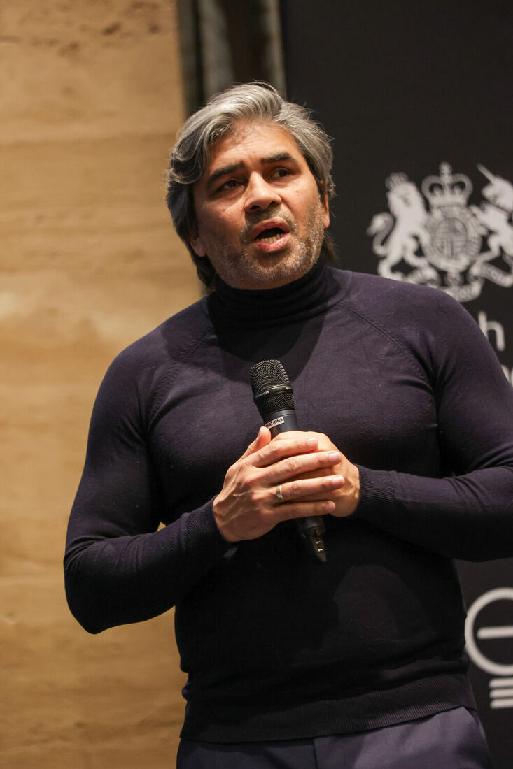 Tarry Singh with a microphone, close in