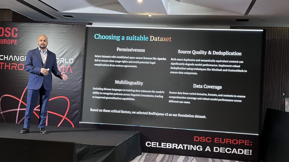 The speaker beside a slide reading Choosing a suitable Dataset, listing permissiveness, source quality, multilinguality and data coverage