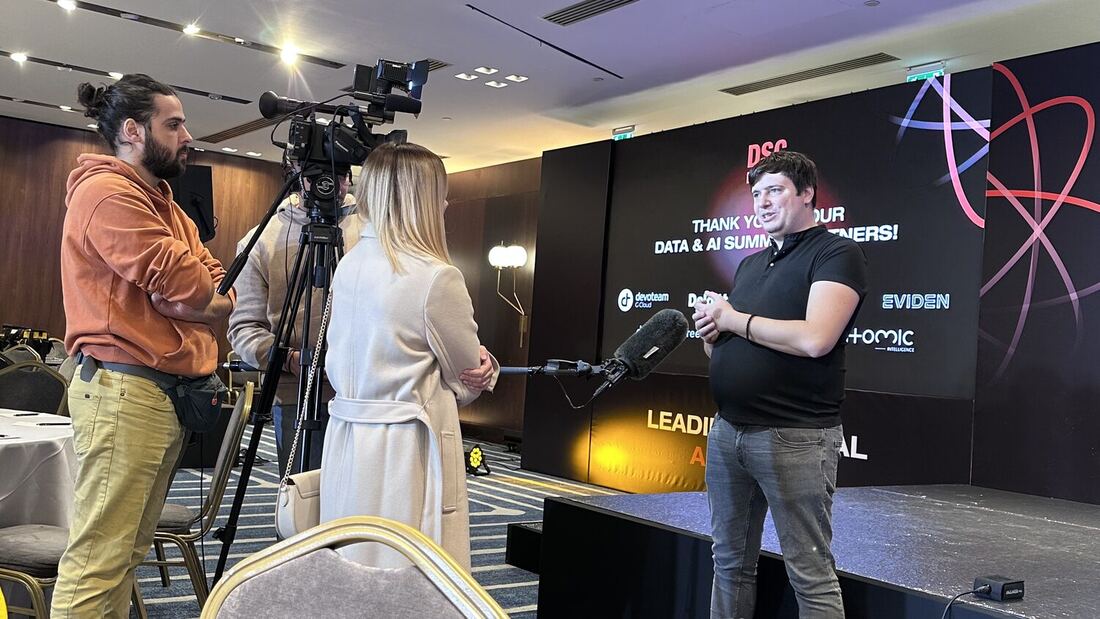 A camera crew films an interview in the main hall