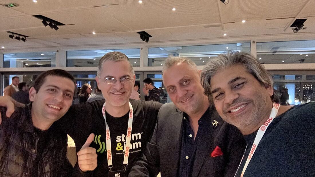 A group of four together at the venue late in the evening