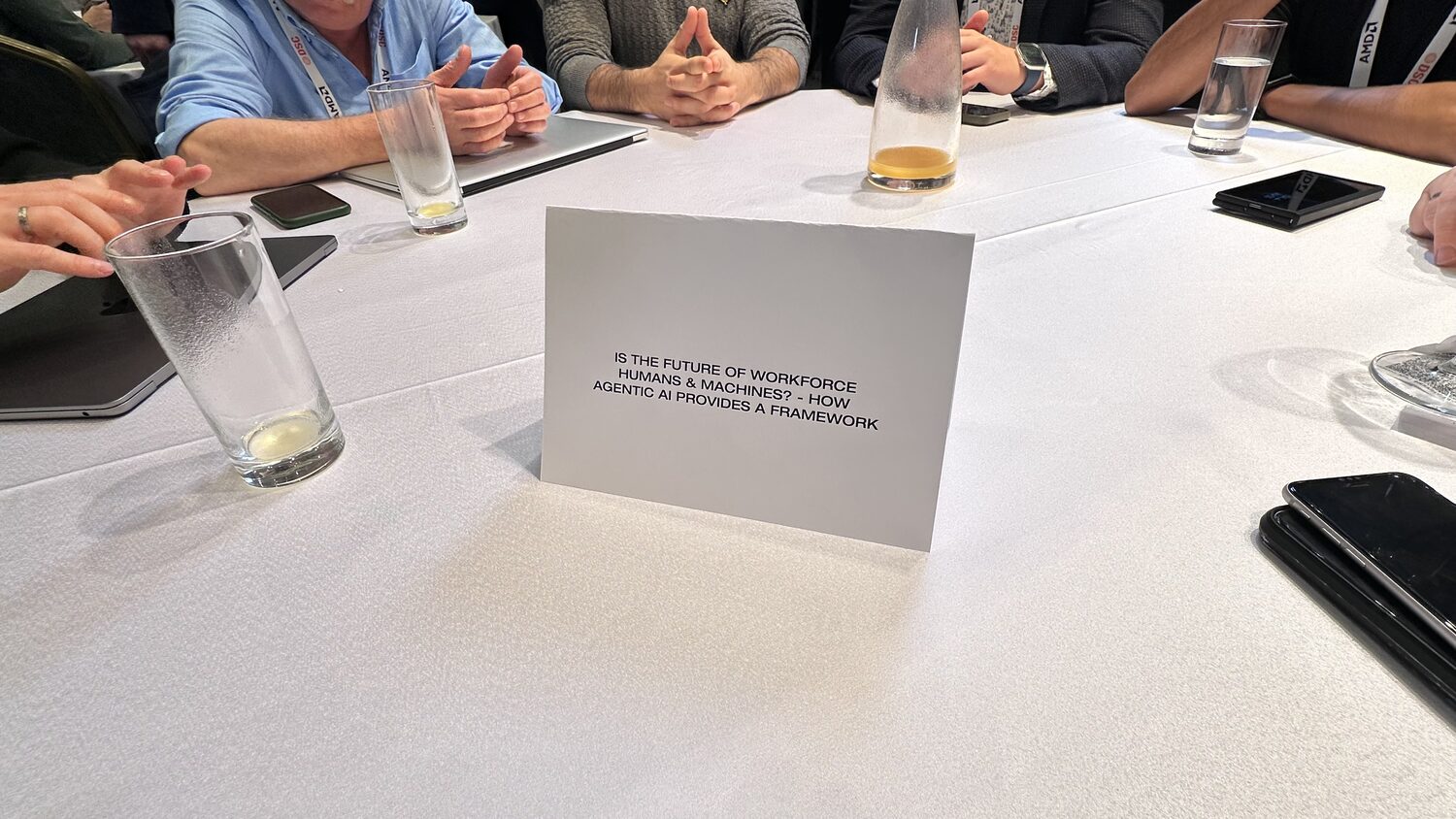 Printed card standing on a roundtable: is the future of workforce humans and machines? How agentic AI provides a framework.