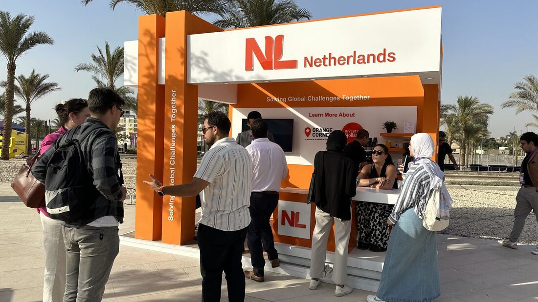 Crowd moving past the NL Netherlands pavilion on the museum concourse