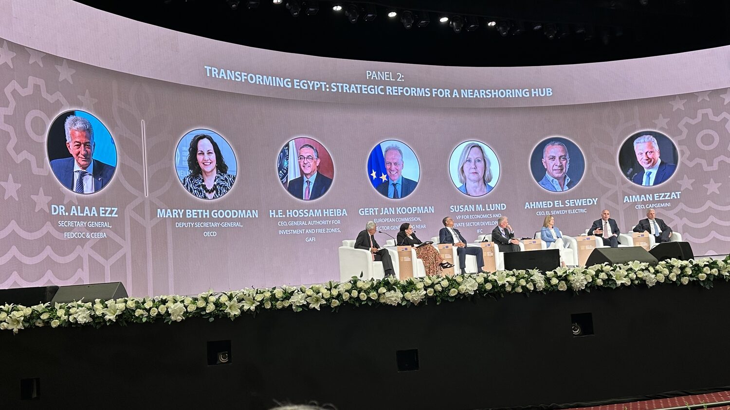 Panel 2, Transforming Egypt: Strategic Reforms for a Nearshoring Hub, the seven speakers seated on stage below their names and portraits on the screen.