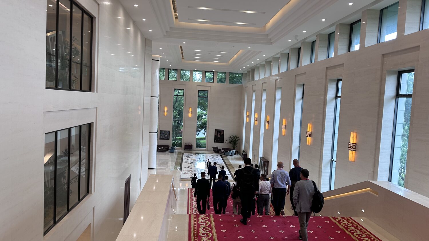 The delegation walking a corridor between sessions at the Shenzhen campus, 30 June.