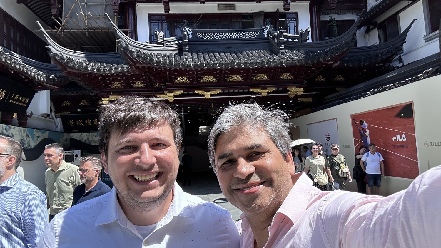 Two delegates in front of a Yu Garden pavilion, Shanghai, 3 July.