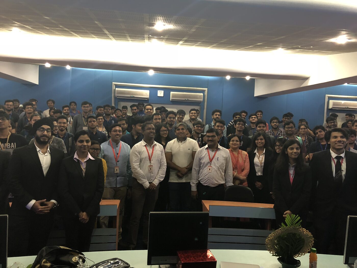 Students filling a tiered auditorium at Thakur College of Engineering and Technology, staff and organisers standing across the front.