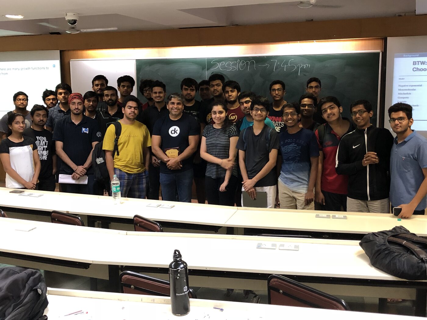 Group photo with the IIT Bombay Analytics Club cohort in a lecture theatre, the session time written on the blackboard behind them.