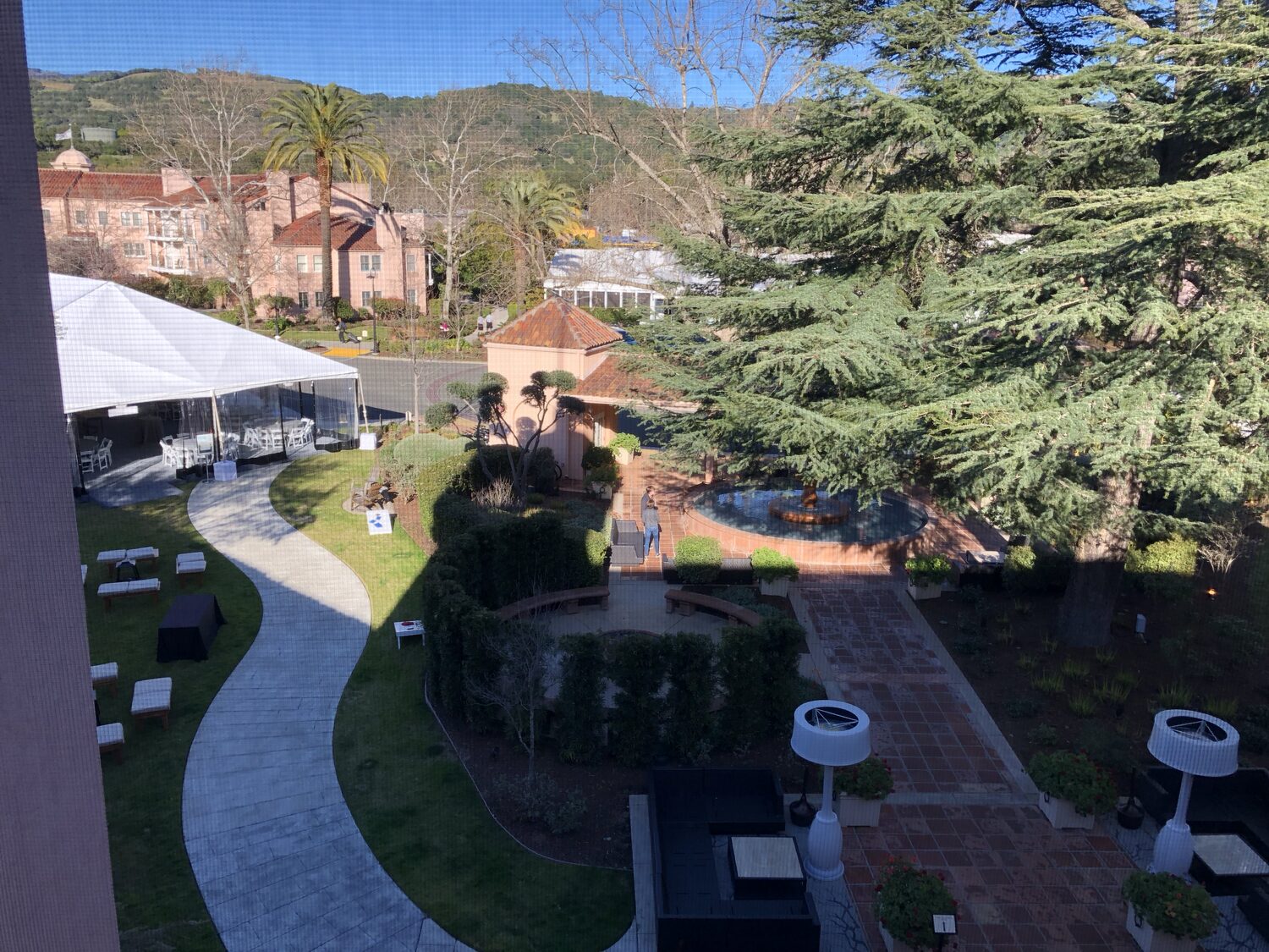 The Sonoma Mission Inn grounds from above, white event marquees pitched on the lawn beside the fountain garden with the Sonoma hills behind