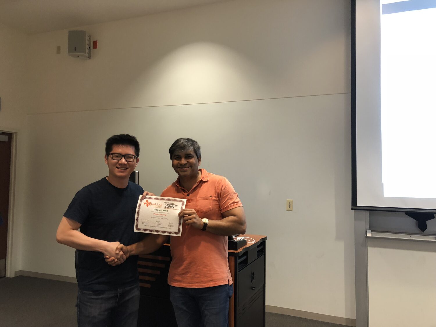 A delegate with the Deep Learning certificate beside the lectern