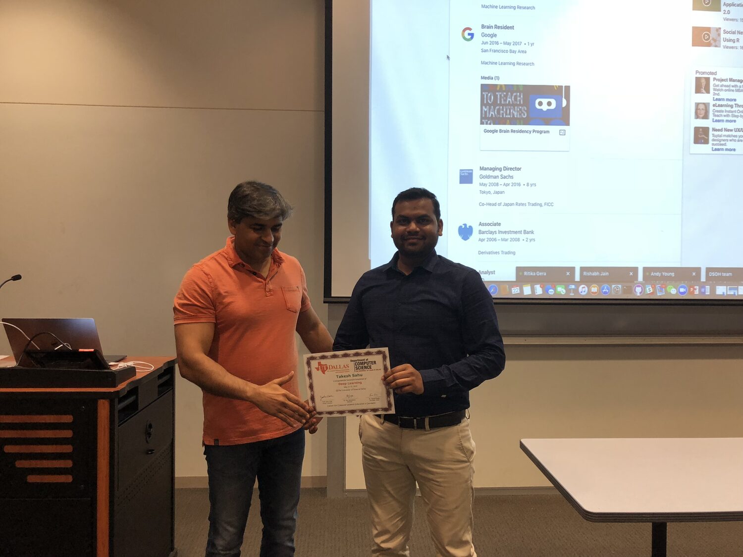 Certificate handover at the front of the UT Dallas classroom