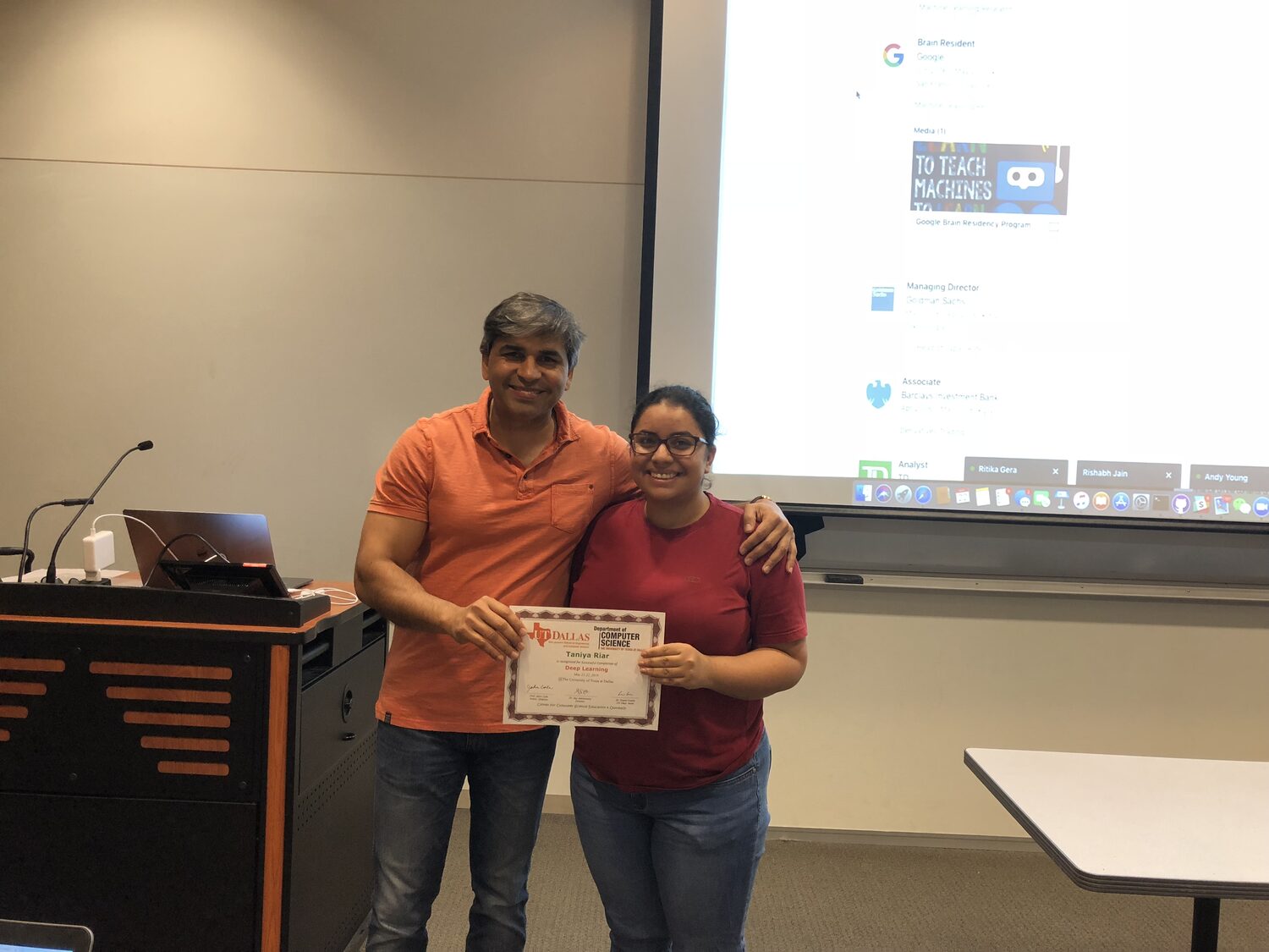 A delegate receives the Deep Learning certificate beside the podium