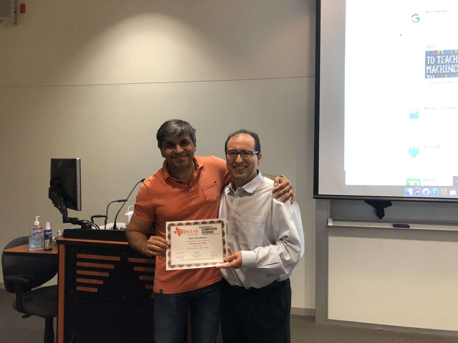 Certificate handover next to the classroom podium