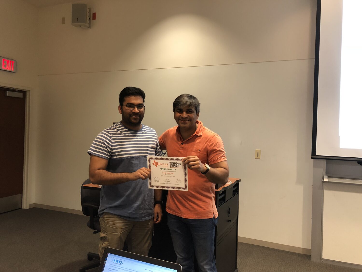 Certificate handover beside the podium at the close of the course