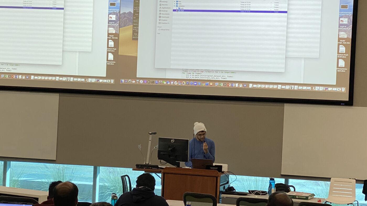 The lecture hall during a session, participants at the benches with laptops open.