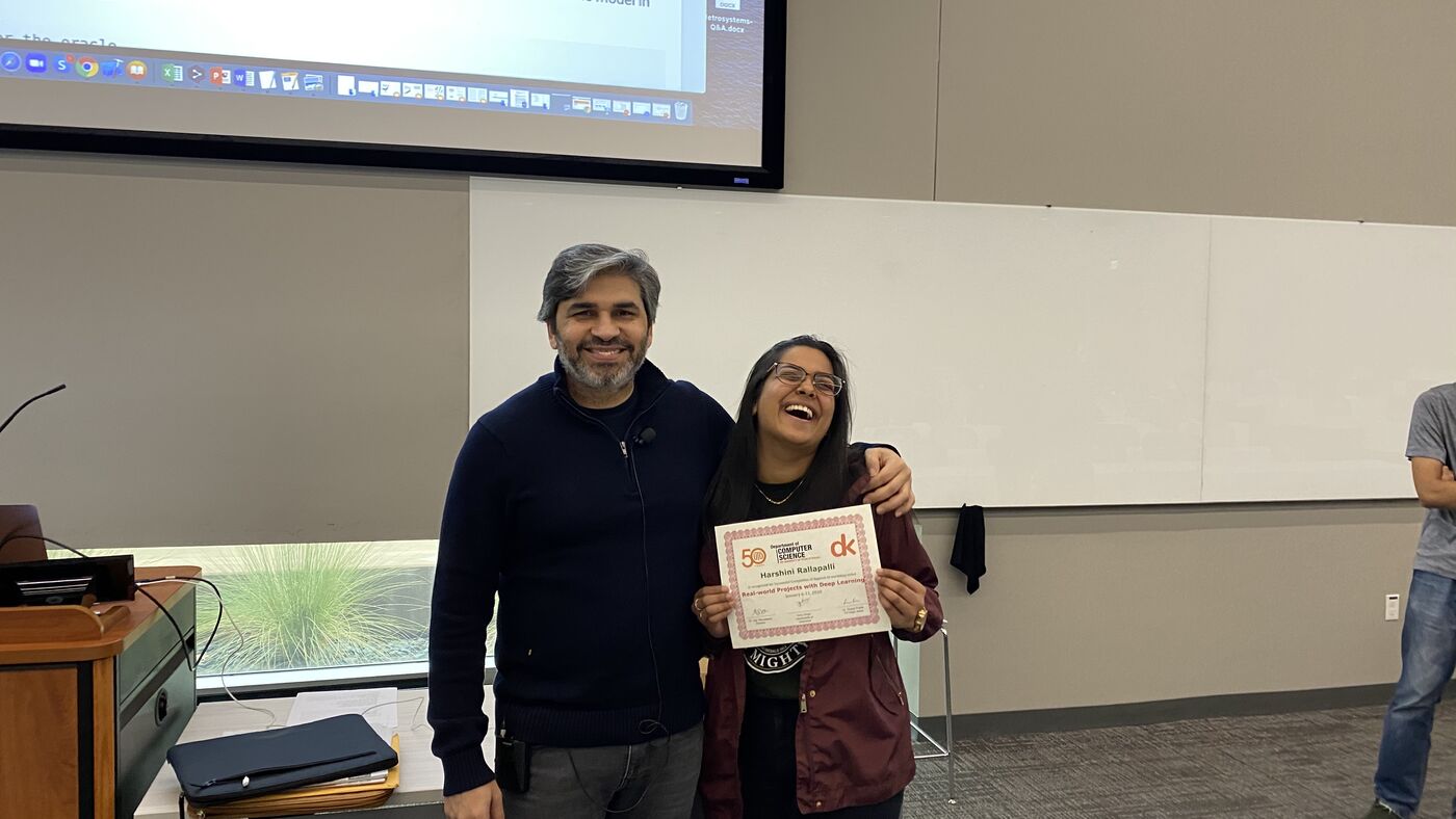 A participant receives the certificate of completion at the front of the hall on the closing day.