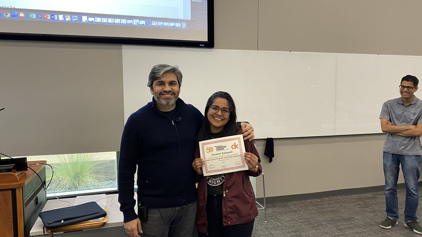 A participant receives the certificate of completion at the front of the hall on the closing day.