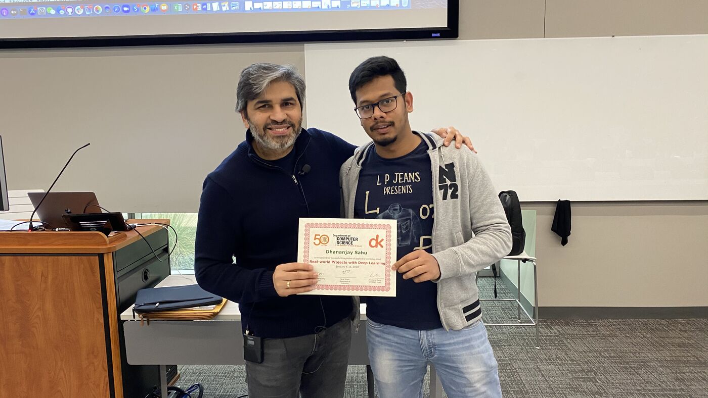 A participant receives the certificate of completion at the front of the hall on the closing day.