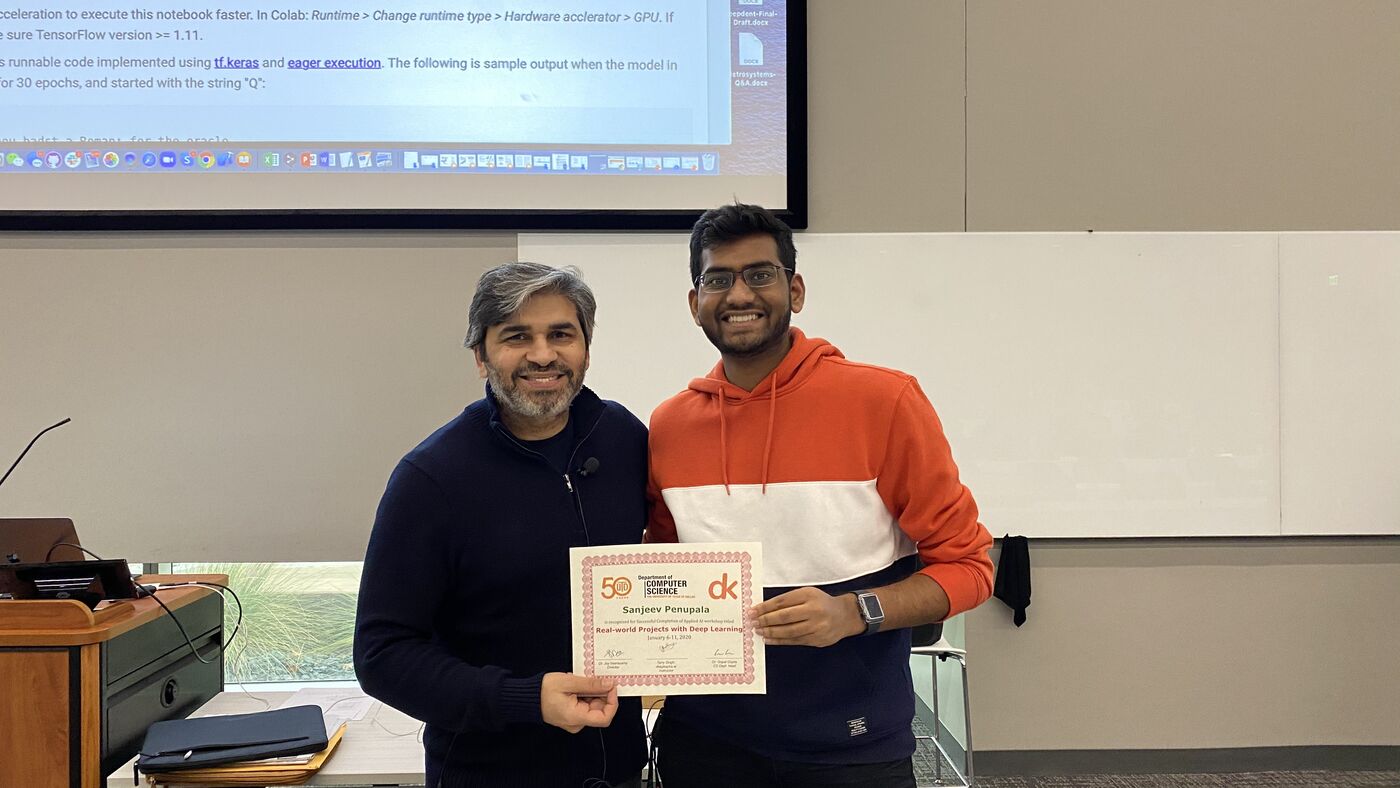 A participant receives the certificate of completion at the front of the hall on the closing day.