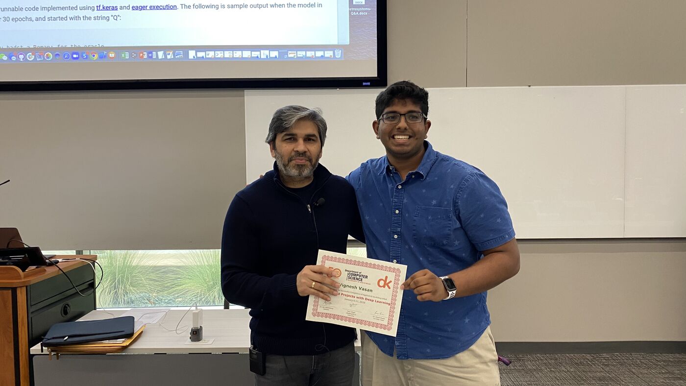 A participant receives the certificate of completion at the front of the hall on the closing day.