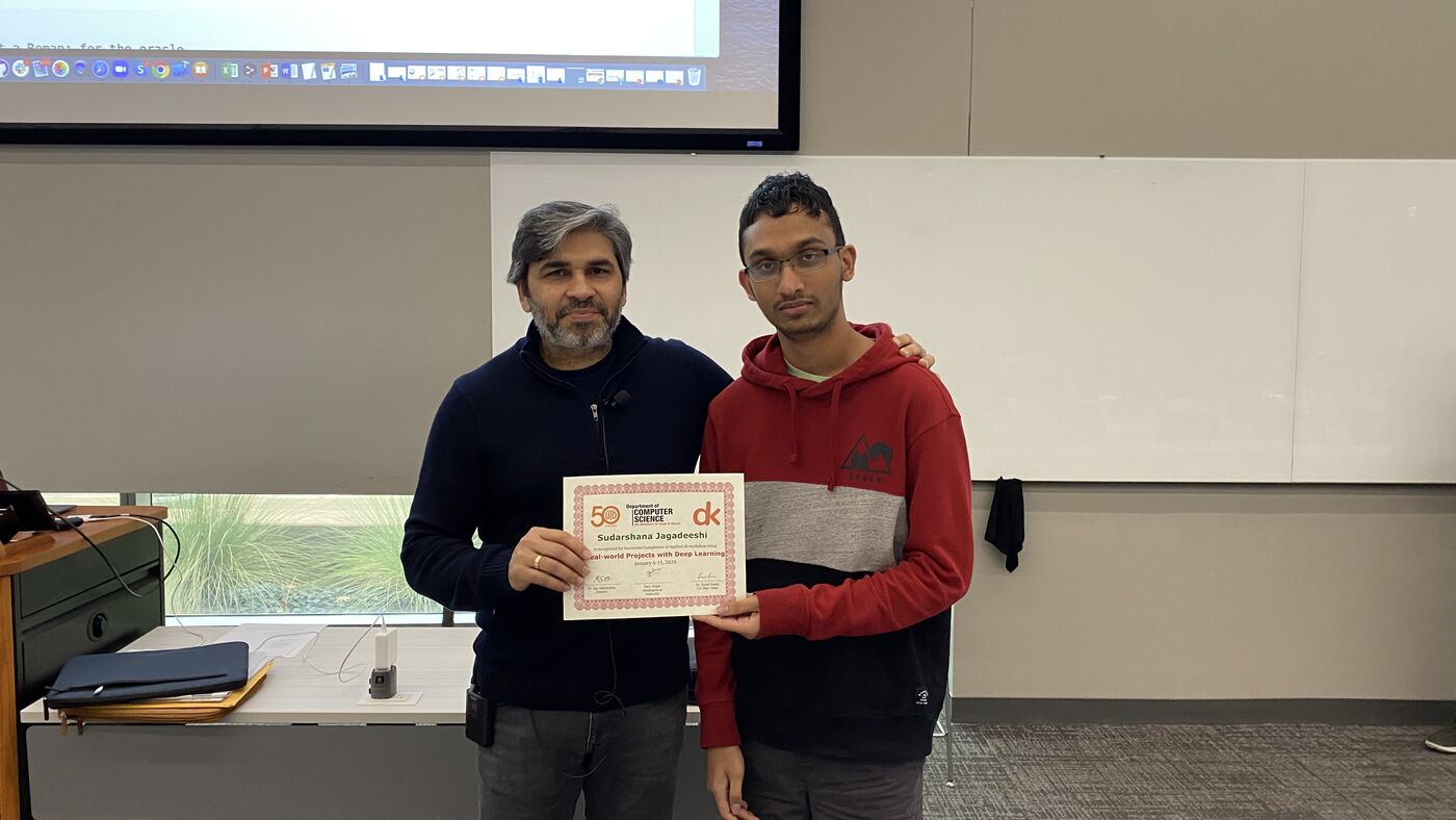 A participant receives the certificate of completion at the front of the hall on the closing day.