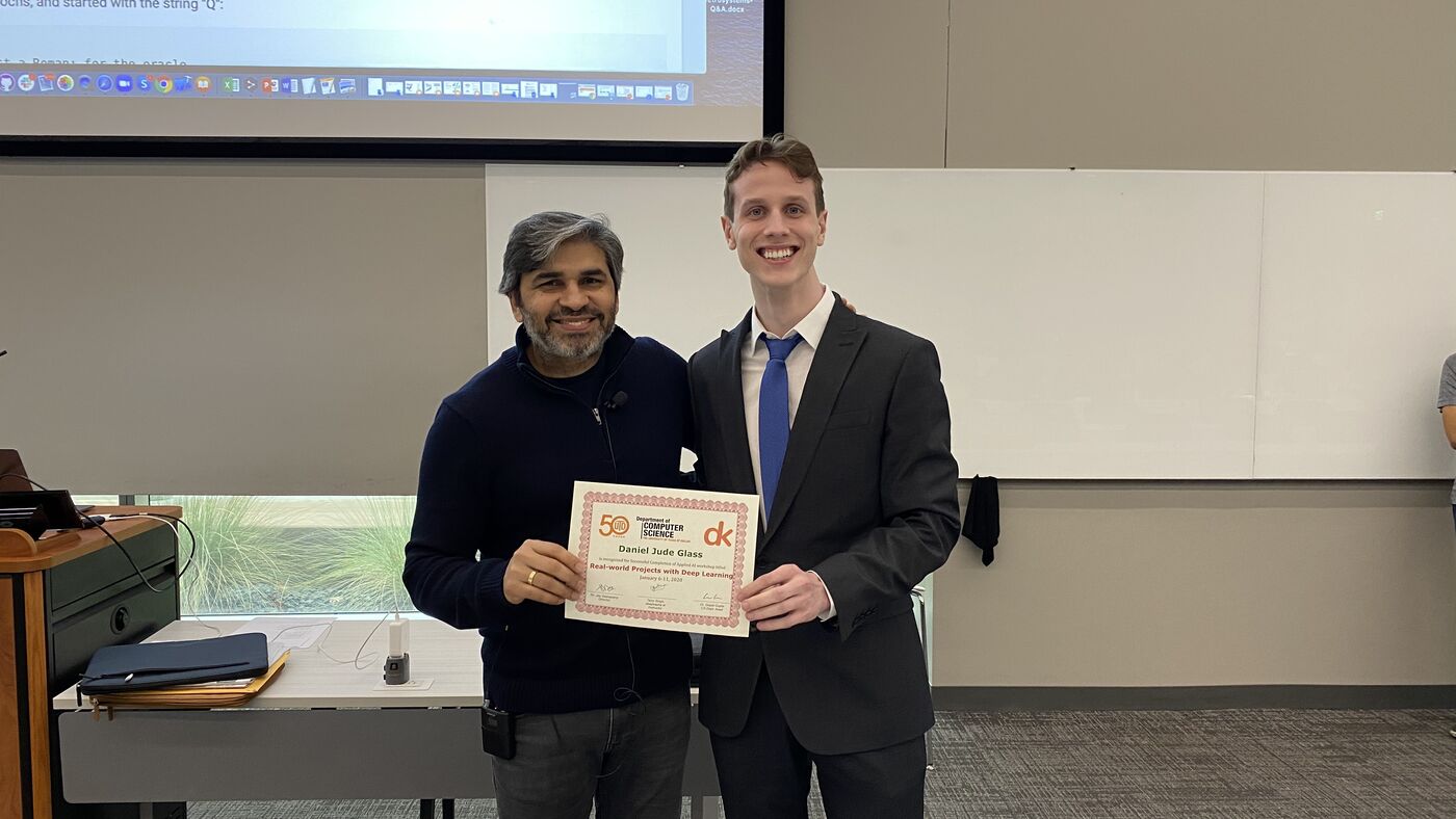 A participant receives the certificate of completion at the front of the hall on the closing day.