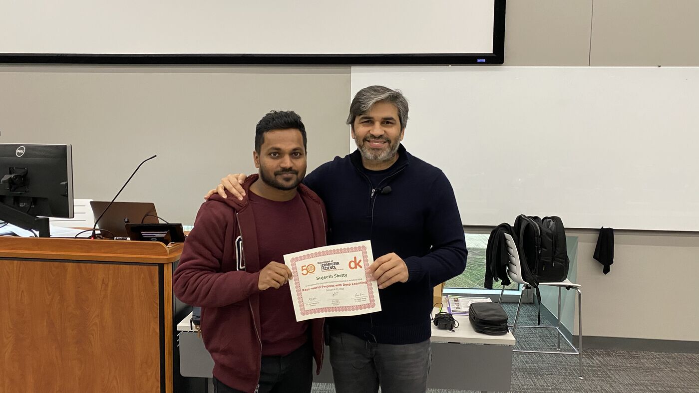 A participant receives the certificate of completion at the front of the hall on the closing day.