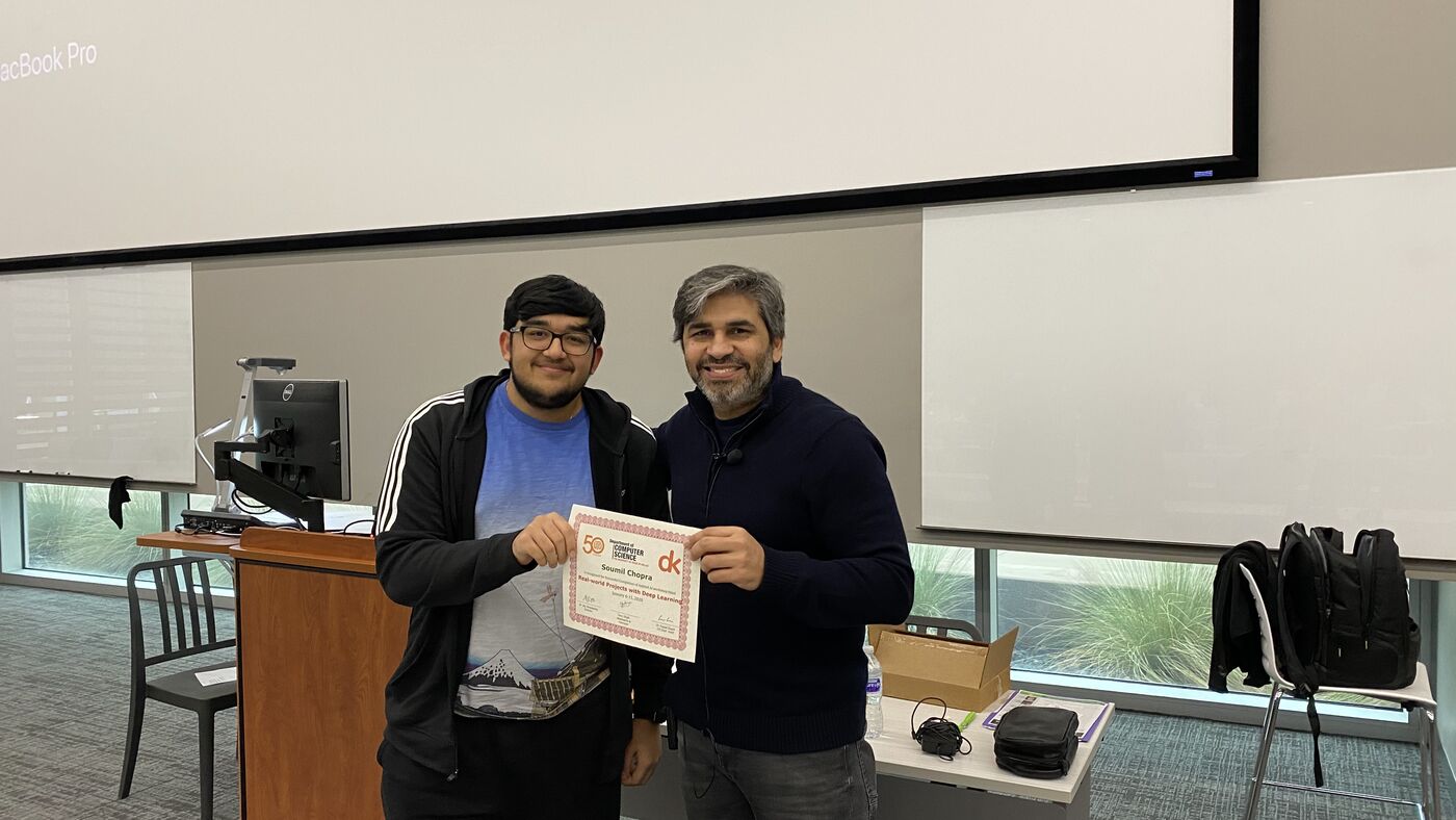 A participant receives the certificate of completion at the front of the hall on the closing day.