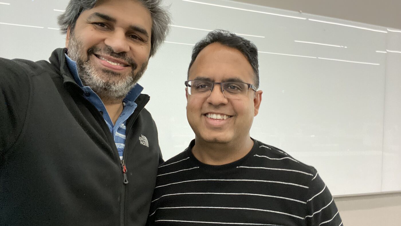 Tarry Singh with a colleague at the front of the lecture hall.